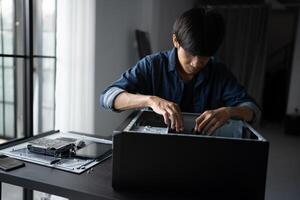 IT Engineer man is working on a computer with a laptop photo