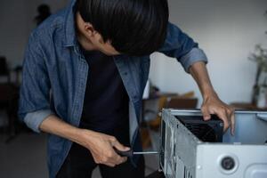 IT Engineer man is fixing a computer case photo