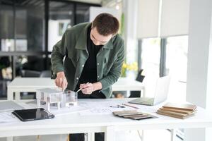 Architecture interior is working on a model of a house photo