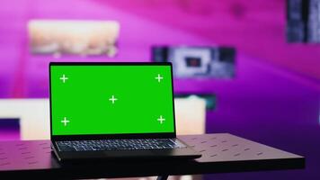 Empty setting with a pc running isolated copy space display under colorful visuals, clips and lights glowing in the dark and creating an urban nightlife clubbing atmosphere. Camera A. video