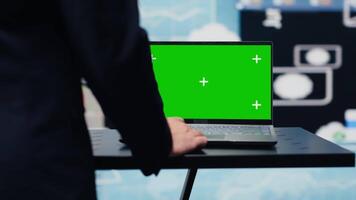 General director with a chroma key display reviewing performance metrics, finance graphs and strategy tools to guide a new investment and decision making. Long term business growth. Camera A. video