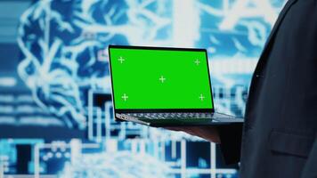 General manager holds chroma key laptop next to AI neural networks, working with deep learning and virtual assistant automation. Business leader uses cloud computing systems. Camera A. video