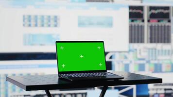 In a business related space, laptop display shows green screen to help with strategy planning with financial data. Representing modern artificial intelligence and productivity for growth. Camera A. video
