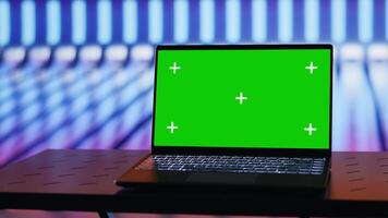 Empty glowing neon lit space with vivid colors and green screen display creates futuristic atmosphere for digital mockup, chroma key edits and artistic visual design in urban style. Camera A. video