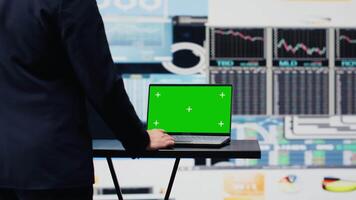 Businessman looks at green screen on phone for annual trends, planning a strategy for corporate success. Analyzing reports and infographics performance metrics to improve activity. Camera A. video