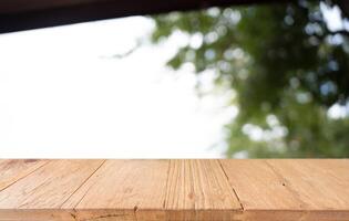 Empty wood table and blur of restaurant background selective focus product display. photo