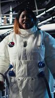 Vertical Astronaut using tablet to check analytics after completing red planet surface mission on unfamiliar planet. Cosmonaut leaving Mars, inputting navigation coordinates on device to return home, camera A video