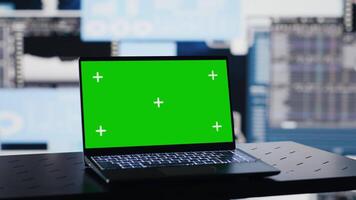 Empty business space has a laptop screen with chroma key, showcasing infographics and reports for effective decision making and strategy planning. Artificial intelligence brain. Camera A. video