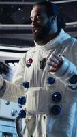 Vertical Joyous astronaut greeting command center researchers during videocall, presenting analysis findings. Smiling orbit station crew member provides scientific findings to Earth team, camera B video