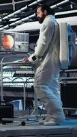 Vertical Cosmonaut doing fist bump with colleague, leaving starship to descend on planet during mankind survival expedition. Astronaut putting helmet on, exiting spaceship to colonize planet, camera A video