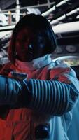 Vertical Astronaut studying cosmic origins talks with command center during videocall to share recent discoveries. Cosmonaut mapping unknown worlds provides scientific findings to Earth team, camera A video