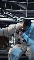 Vertical Astronauts checking human expansion in space mission logs on isolated screen monitor. Teamworking cosmonaut looking at mockup display during mankind survival expedition, camera A video
