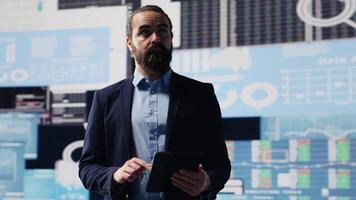 Surrounded by virtual graphs and forecasting models, chief executive officer uses financial data and insight to drive business growth. Ensuring performance and smart decision making. Camera A. video