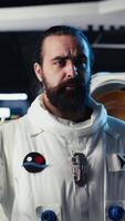 Vertical Upbeat astronaut greeting researchers during videocall presenting research data gathered during flight. Friendly woman in space station provides experiments observations to Earth team, camera B video