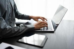a person typing on a laptop computer coding photo