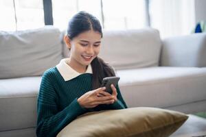 Young woman user customer hold smart phone Social media addiction with finger rings using online app on mobile phone browsing Internet chatting on social media photo