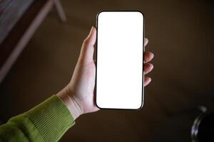 person hand holding up a blank white smartphone screen. photo