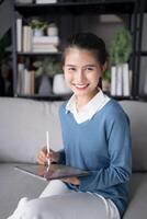 Asian woman Graphic designer working on digital tablet. artist drawing on graphic tablet female Artist Creative Designer sketch graphic drawing creative studying work on tablet at home. photo
