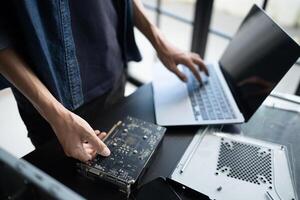a person is working on a computer with a laptop photo