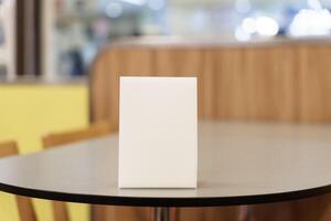 Menu mock up white square box on top of a table photo