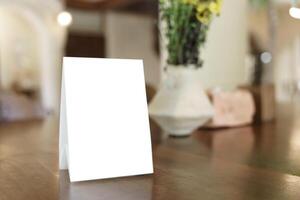 Menu mock up blank for text marketing promotion. Mock up Menu frame standing on wood table in restauran photo