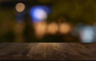 wood table and blur of restaurant background focus product display. photo