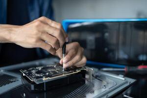 IT Engineer installing Hardware repairing a computer with a screwdriver photo
