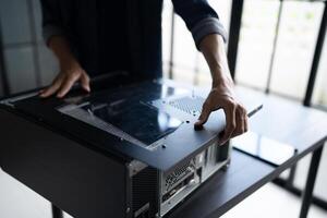 IT Engineer installing Hardware holding a computer case photo