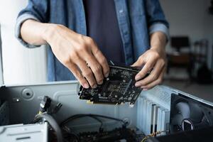 IT Engineer installing Hardware fixing a computer motherboard photo