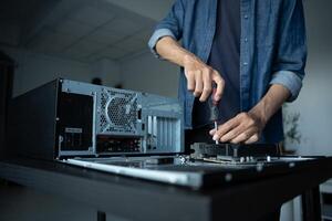 IT Engineer installing Hardware working on a computer with a screwdriver photo
