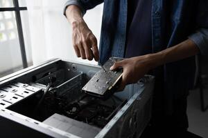 a man is fixing a computer case. photo