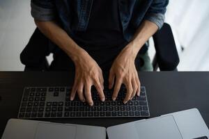Asian man software engineer Working on Computer for writing program code IT Software Engineer finding errors devops creating digital photo
