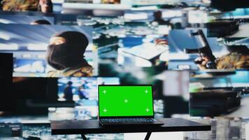 Copy space mockup on laptop display next to satellite imagery of enemy forces, modern armed forces tools used to gather intelligence helpful for war planning and combat operations. Camera B. video