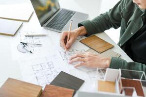 a man is working on a project with some architectural plans photo