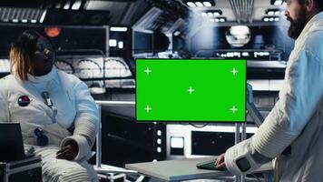 Researchers flying together in starship, looking at green screen monitor, exploring Mars. Cosmonauts using mockup display to ensure operational readiness before landing on red planet, camera B video