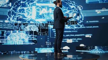 Male business person studies artificial intelligence strategy and automation tools. Surrounded by data visualization, neural networks and cloud computing, he explores smart technology. Camera B. video