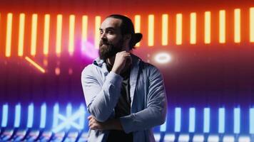 Trendy young person posing in neon lit futuristic environment, capturing the essence of youth culture, creativity and minimalism with a retro digital twist and strong street wear influence. Camera A. video