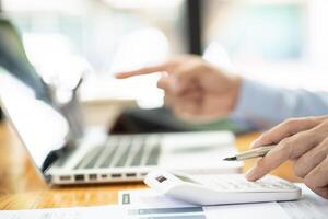 Business man working by using laptop computer Hands typing on a keyboard. Professional investor working new start up project. business planning in office. photo