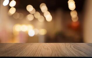 empty wooden table top over blurred background with bokeh effect photo
