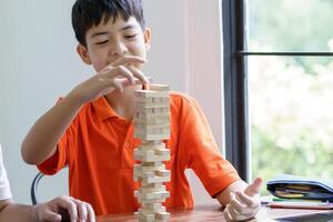 a boy playing with wooden blocks photo