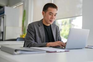 Business man working using laptop computer Hands typing keyboard. Professional investor working start up project. business planning in office. photo