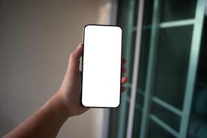 Smart phone mockup. Woman hands holding cell telephone blank copy space screen smartphone blank white screen isolated technology concept. photo