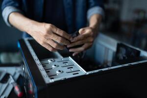 a man is fixing a computer case in room photo