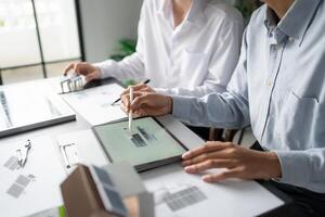 two people working on a project at a table photo