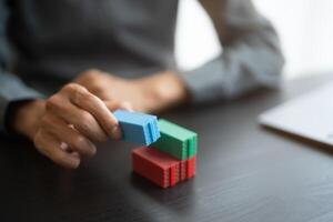 a person is holding a stack of colorful blocks photo