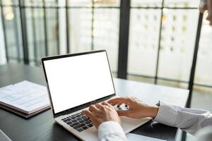 Business man using laptop blank screen computer working in office mockup blank screen computer white background. photo