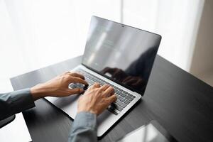 Business man working with laptop Hands typing keyboard working new start up project. business planning in office. Technology business. photo