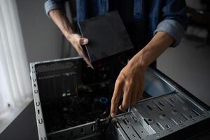 an IT engineer is holding a computer case photo