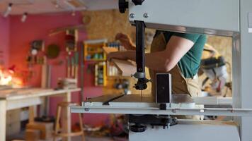 Using band saw machine vertical equipment for straight curved angled cuts. Carpenter work in studio video