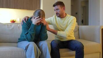 Grieving woman sobbing, husband comforting consoling with gentle hug, shared sorrow palpable video